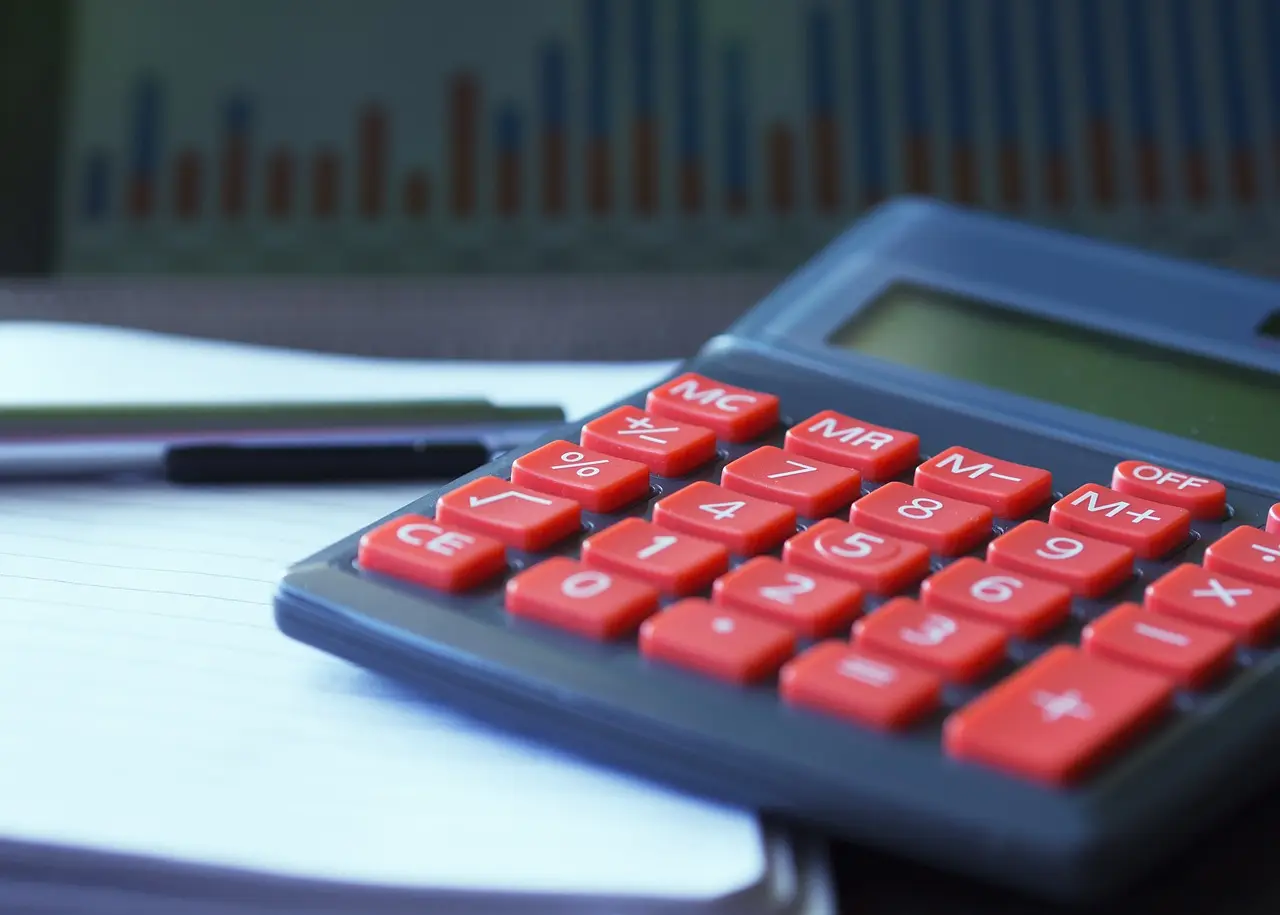 Picture of a desk set up for working out costs